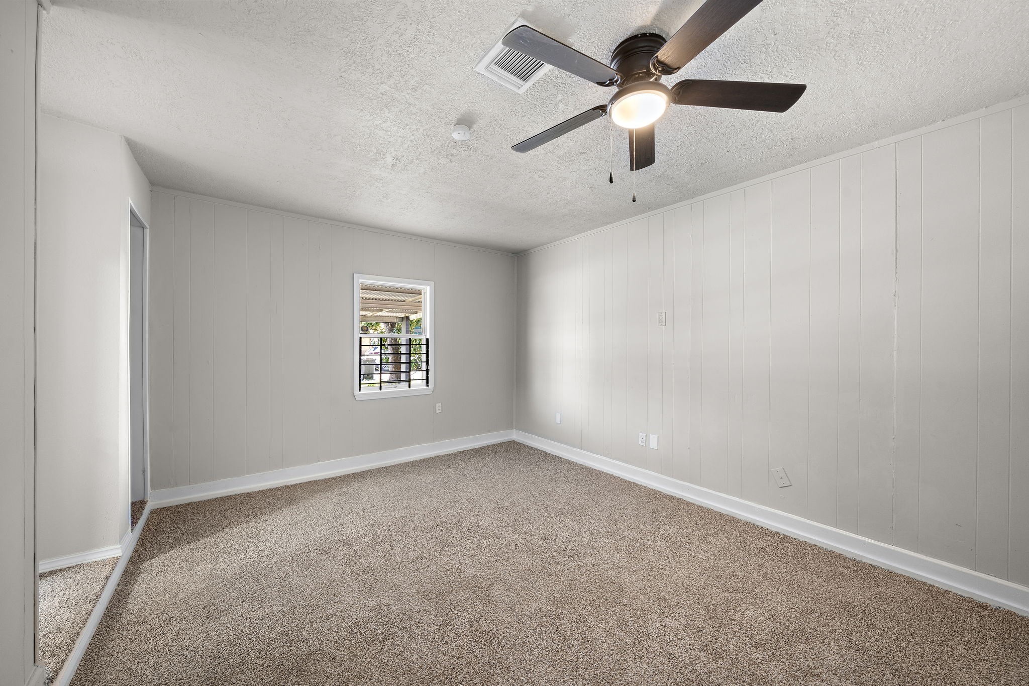 3121 Chimira Lane Houston, TX 77051 - Photo 21 of 35 an empty room with a window and a fan
