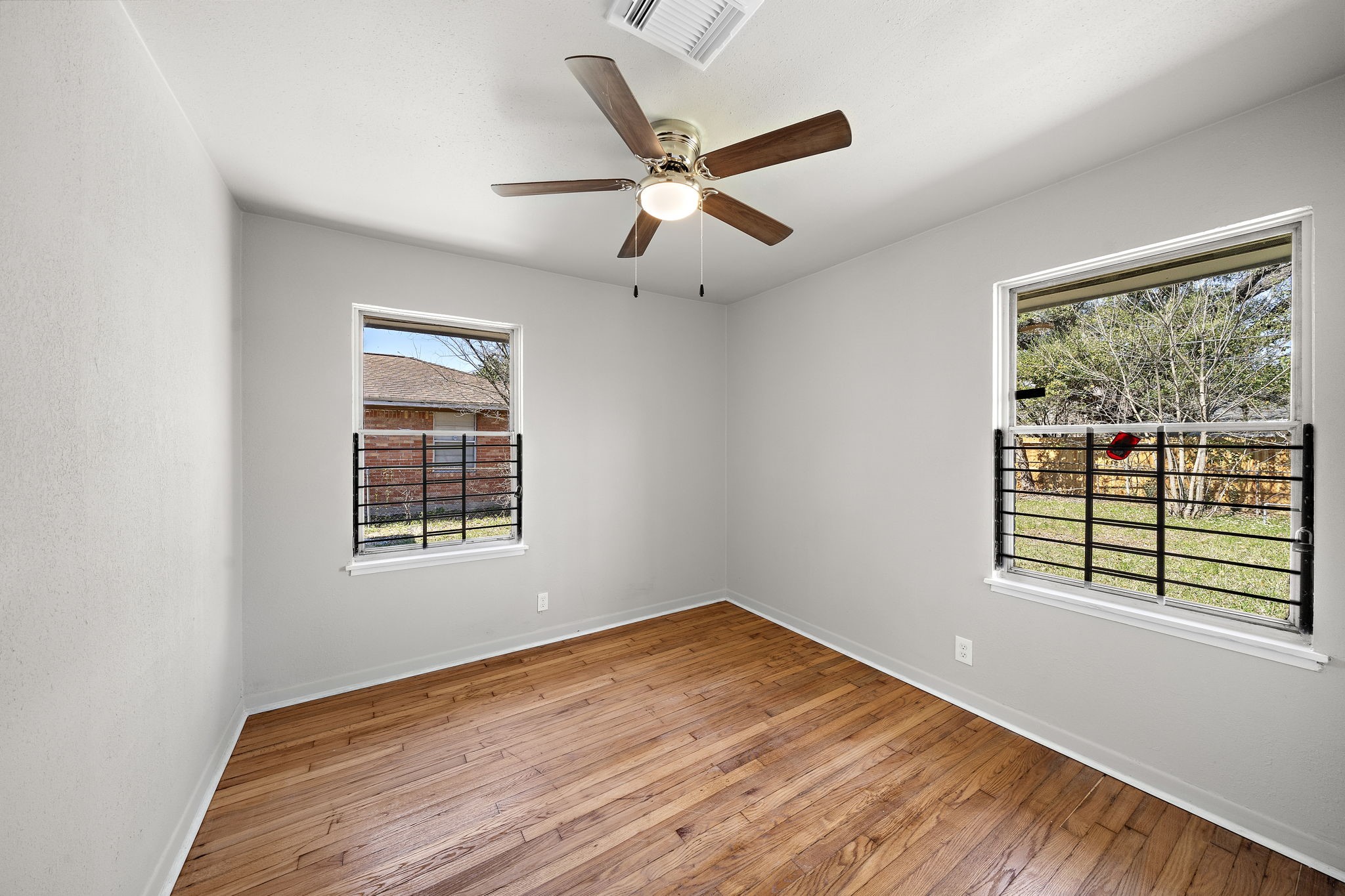 3121 Chimira Lane Houston, TX 77051 - Photo 27 of 35 a view of an empty room with wooden floor and a window