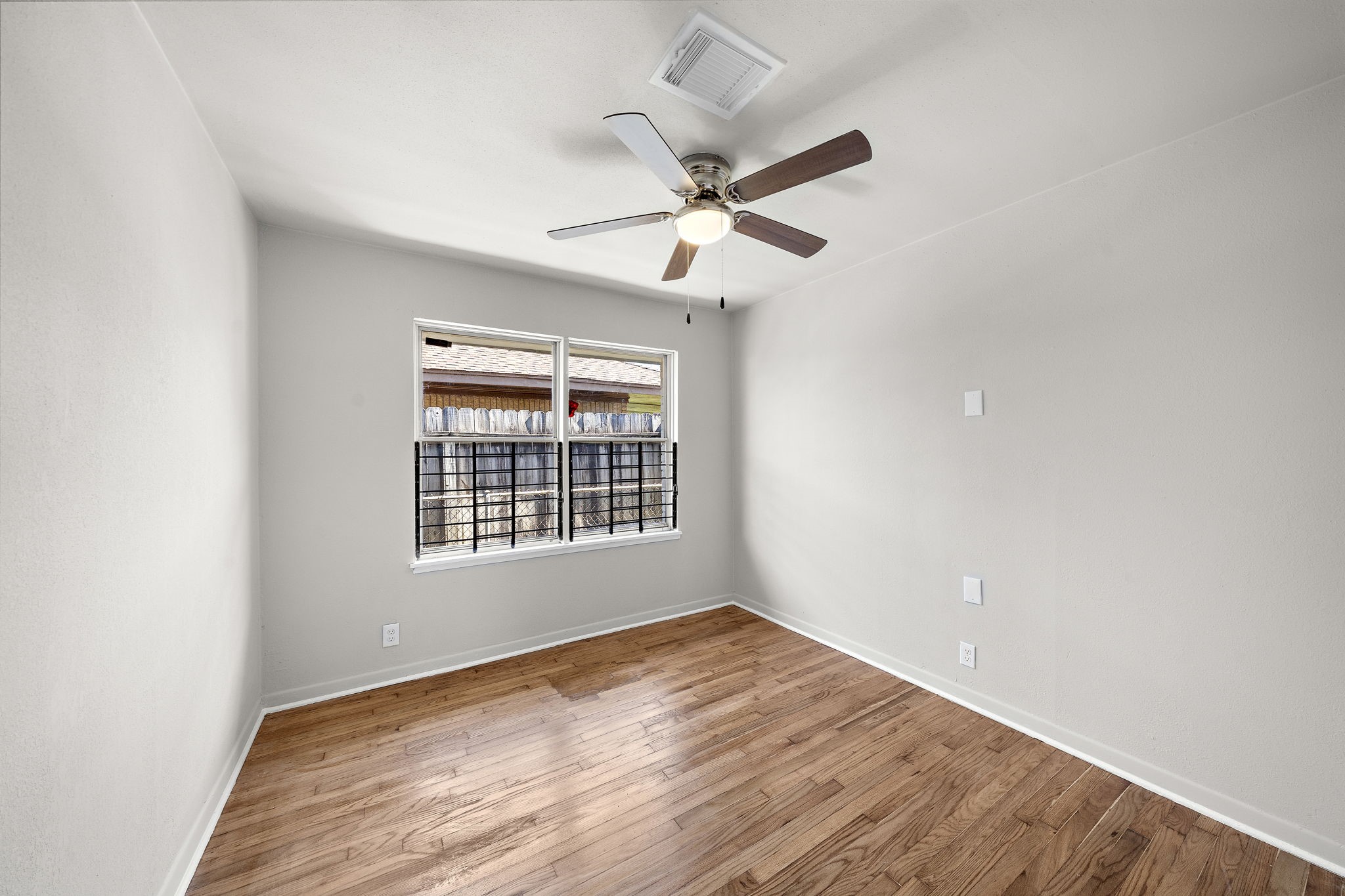 3121 Chimira Lane Houston, TX 77051 - Photo 31 of 35 a view of an empty room with wooden floor and a window