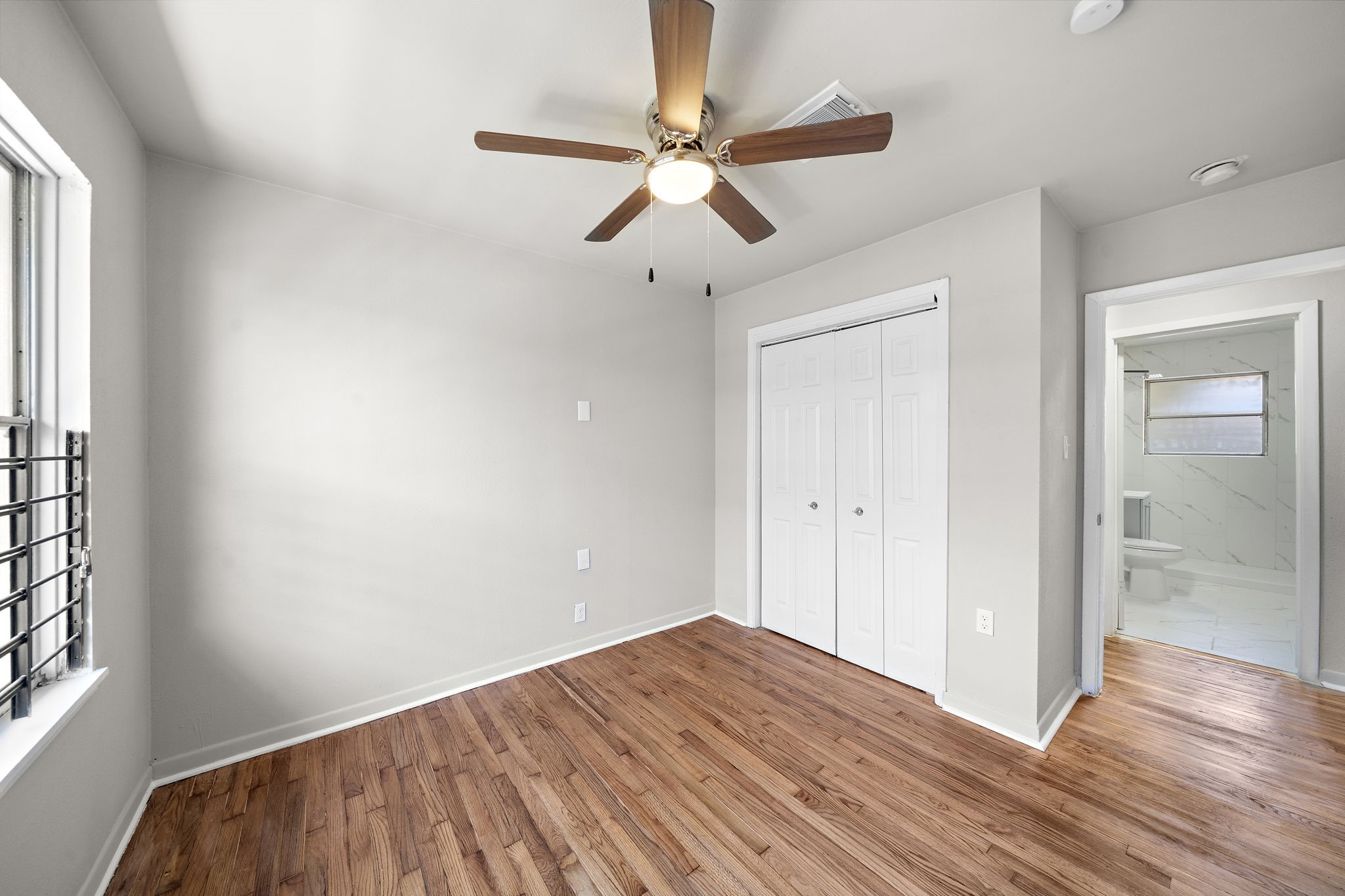 3121 Chimira Lane Houston, TX 77051 - Photo 32 of 35 a view of empty room with wooden floor and ceiling fan