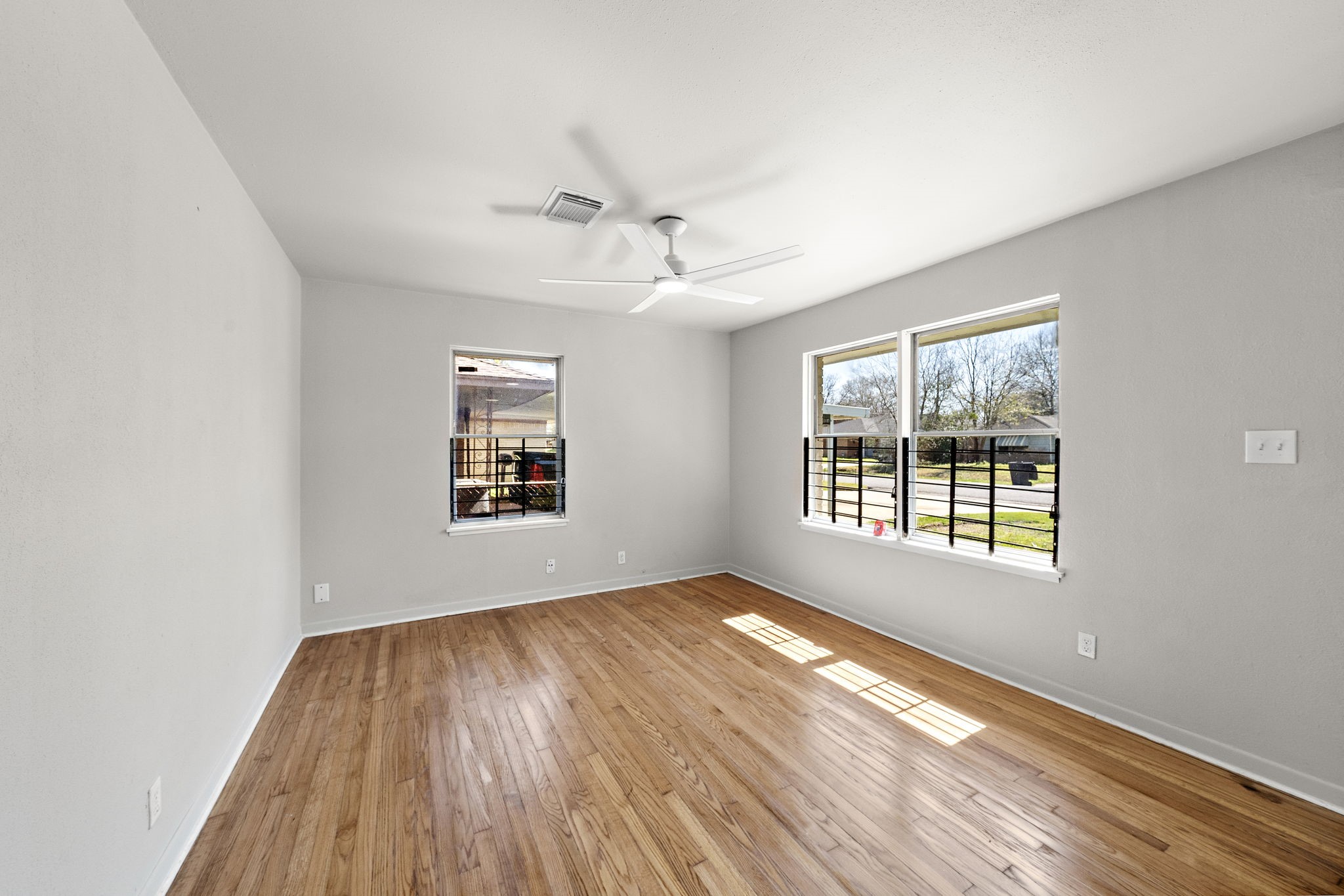 3121 Chimira Lane Houston, TX 77051 - Photo 5 of 35 a view of an empty room with wooden floor and a window