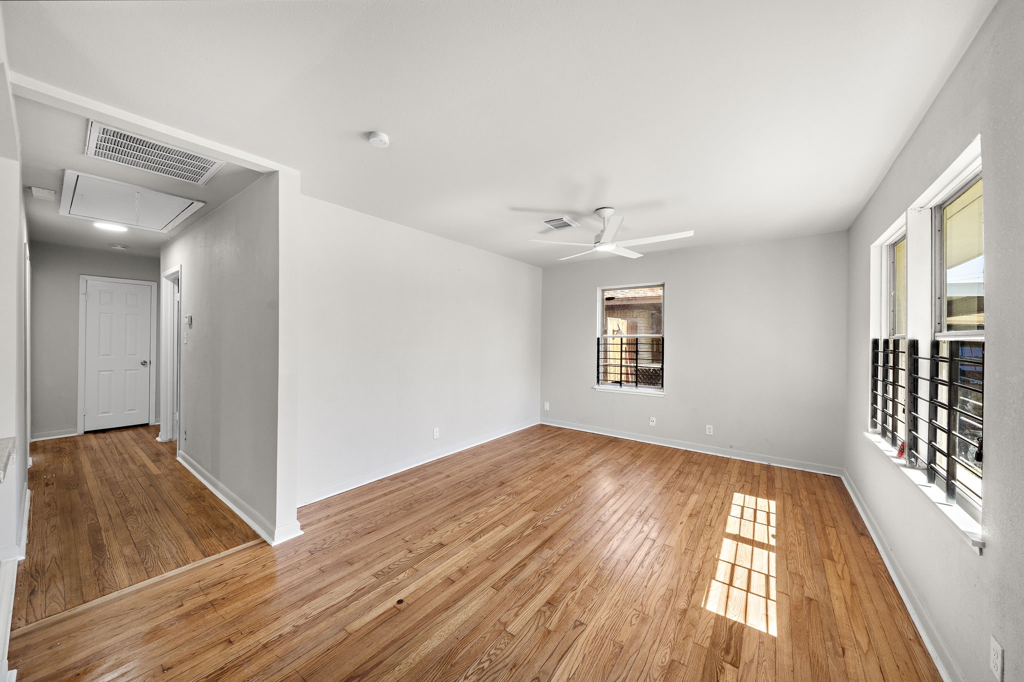 3121 Chimira Lane Houston, TX 77051 - Photo 6 of 35 an empty room with wooden floor and windows