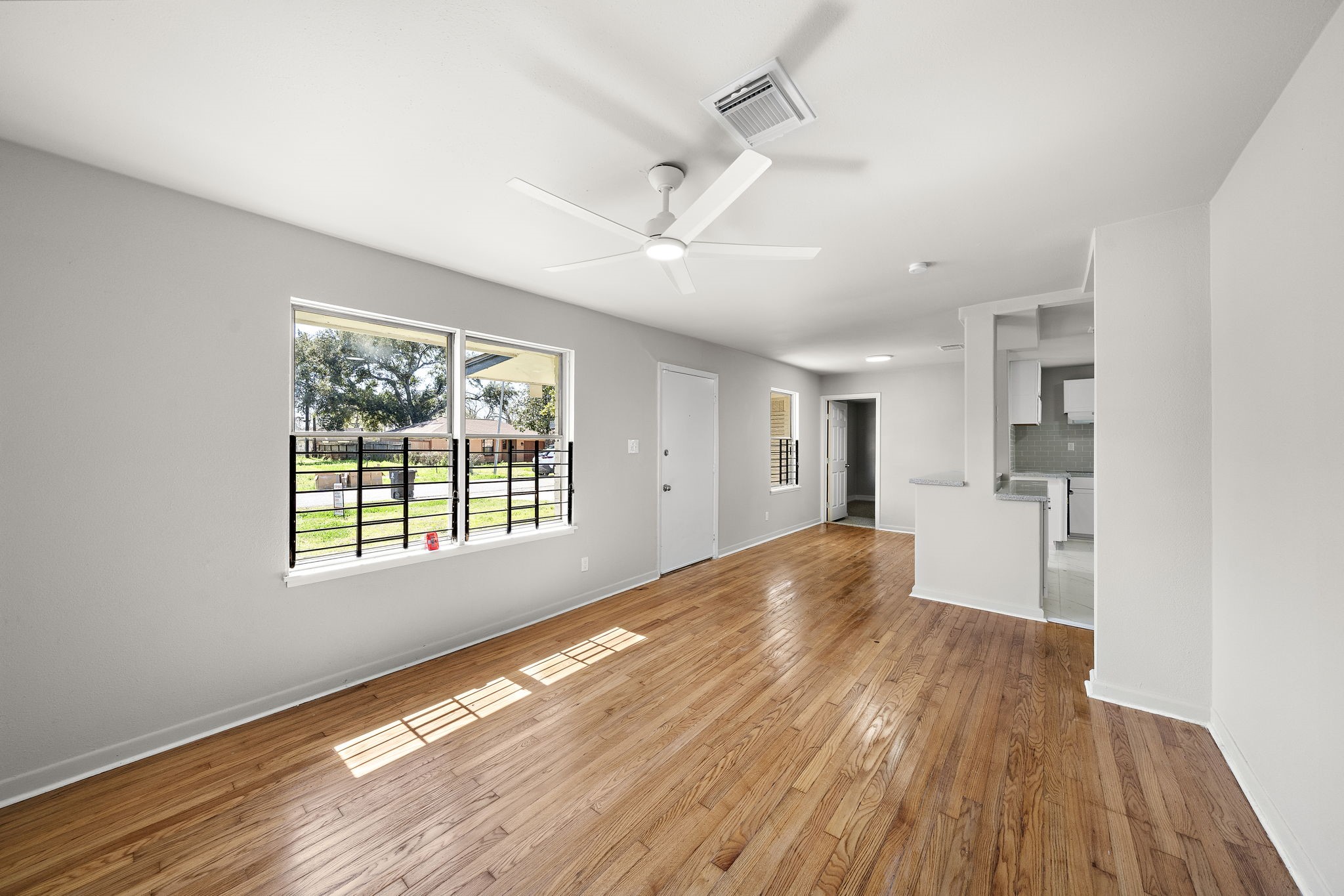 3121 Chimira Lane Houston, TX 77051 - Photo 8 of 35 a view of empty room with wooden floor and fan