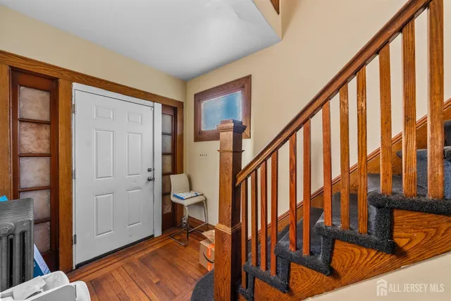 a view of an entryway with wooden floor and stairs