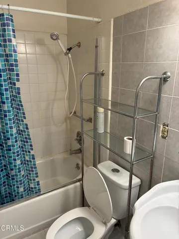 a bathroom with a toilet and shower
