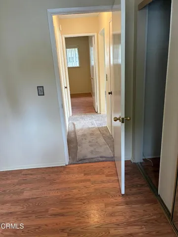 a view of a hallway with wooden floor and a hallway