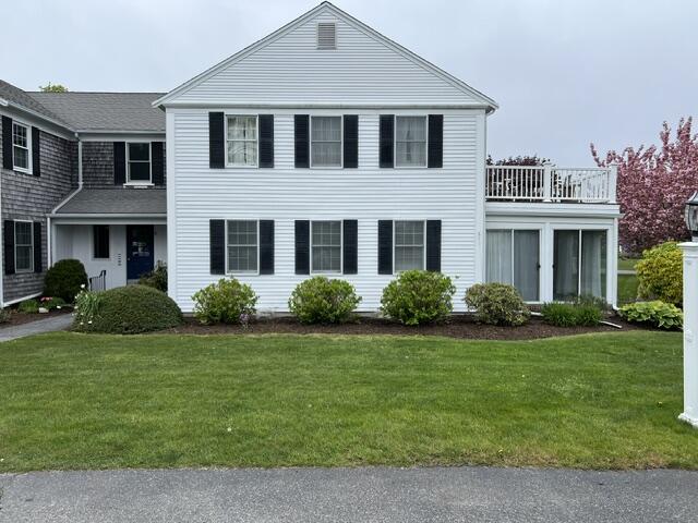 99 Depot Road, Unit 23 Chatham, MA 02633 - Photo 1 of 4 a front view of a house with a yard