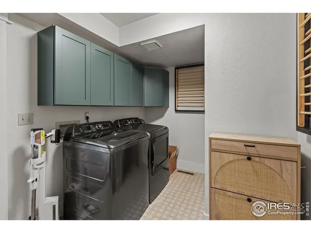 a utility room with sink dryer and washer