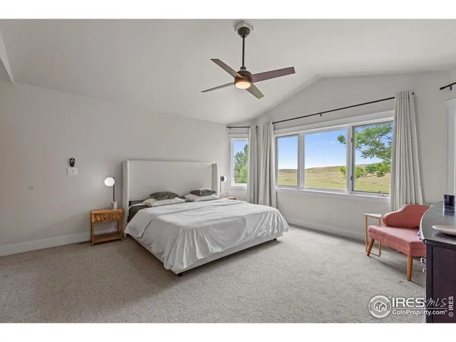 a bedroom with a bed window and couch