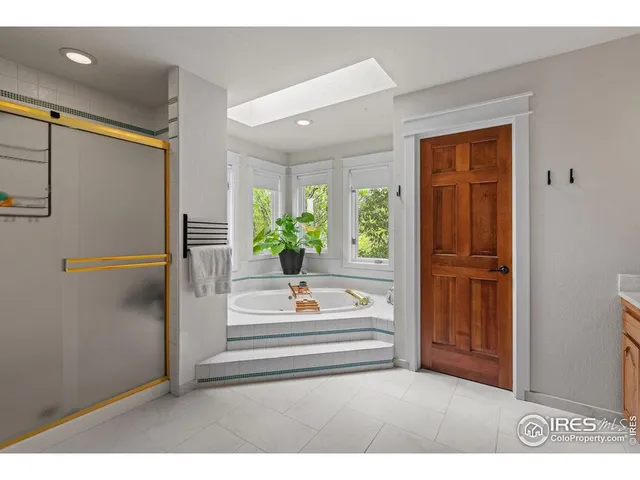 a bedroom with furniture and a large window