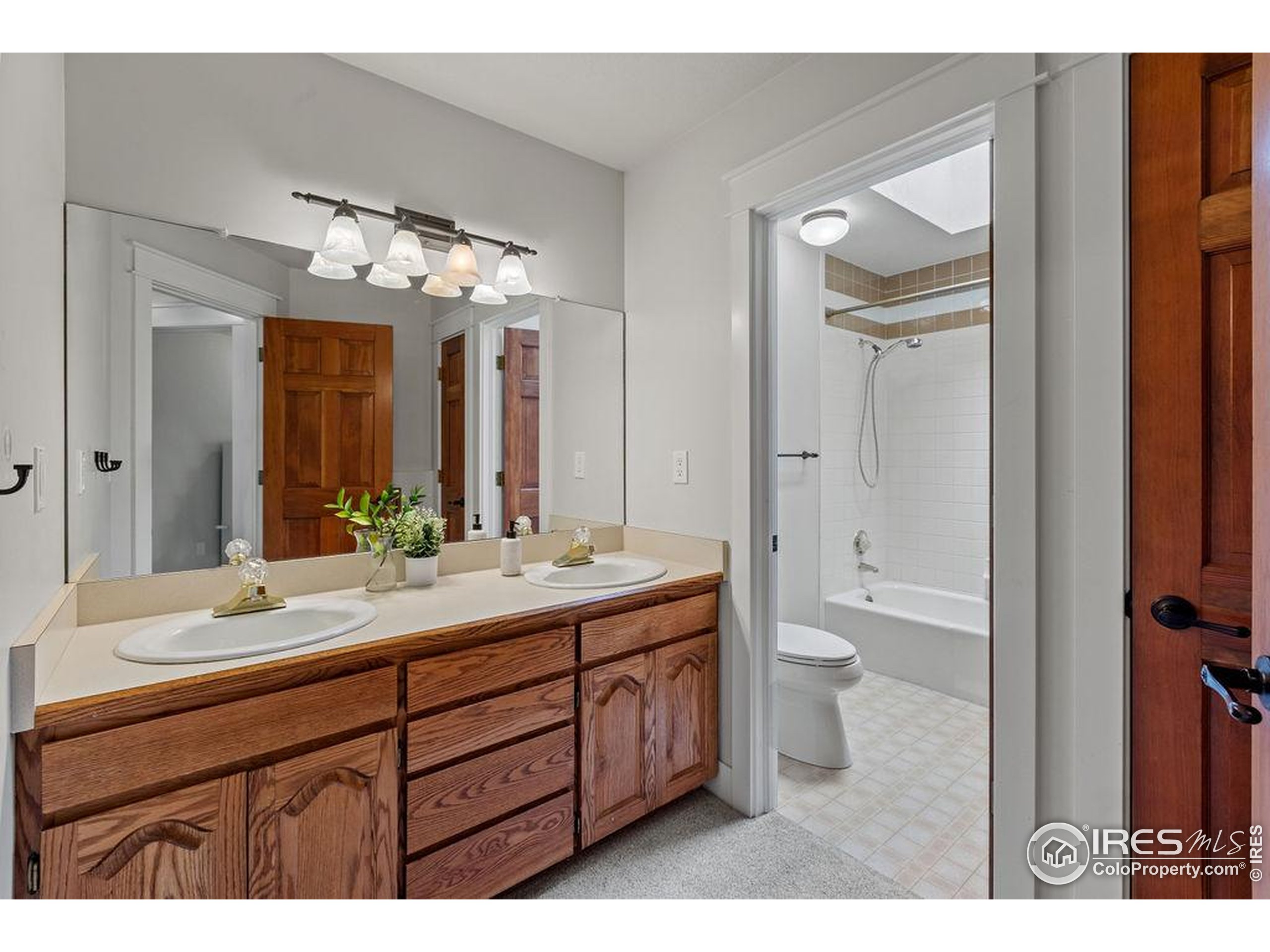 2213 Grosvenor Court Fort Collins, CO 80526 - Photo 25 of 40 a bathroom with a double vanity sink and a mirror