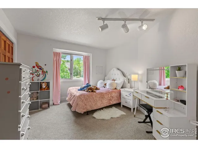 a bedroom with furniture and a large window