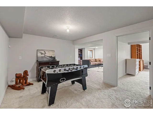 a living room with two beds and a table