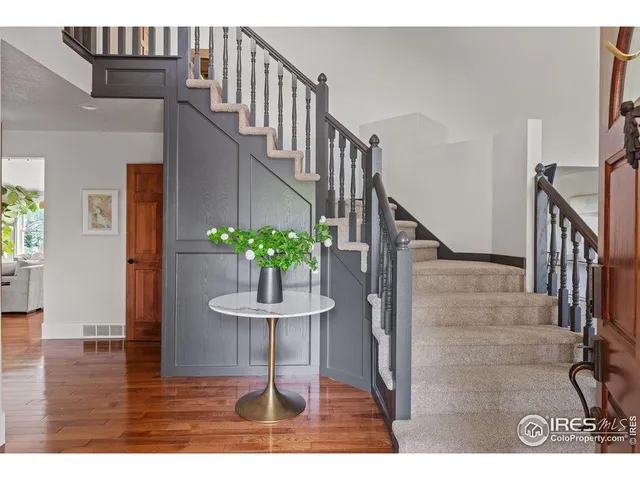 a view of entryway and hall with wooden floor