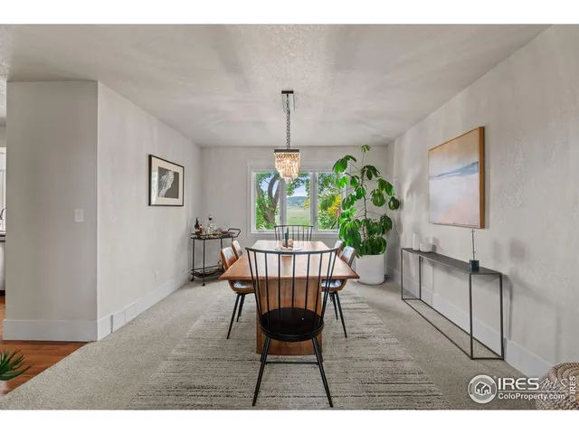 a dining room with furniture and wooden floor