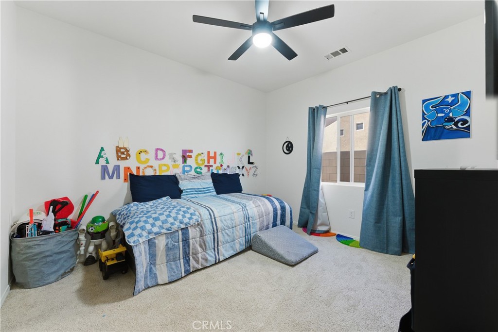 2036 East Jenner Street Lancaster, CA 93535 - Photo 23 of 50 a bedroom with bed and a window