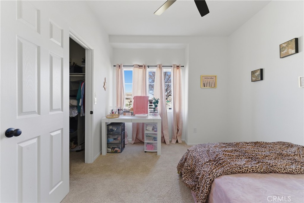2036 East Jenner Street Lancaster, CA 93535 - Photo 29 of 50 a bedroom with a bed and a chandelier