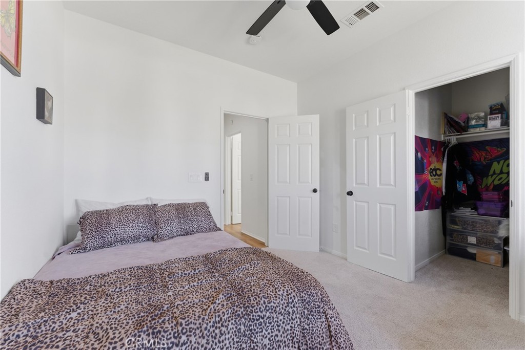 2036 East Jenner Street Lancaster, CA 93535 - Photo 30 of 50 a bedroom with a bed and a tv