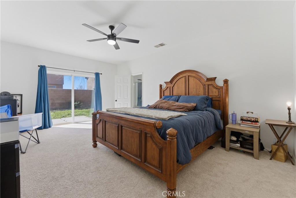 2036 East Jenner Street Lancaster, CA 93535 - Photo 31 of 50 a spacious bedroom with a bed and a desk
