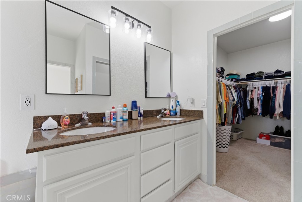 2036 East Jenner Street Lancaster, CA 93535 - Photo 35 of 50 a bathroom with a sink and a mirror