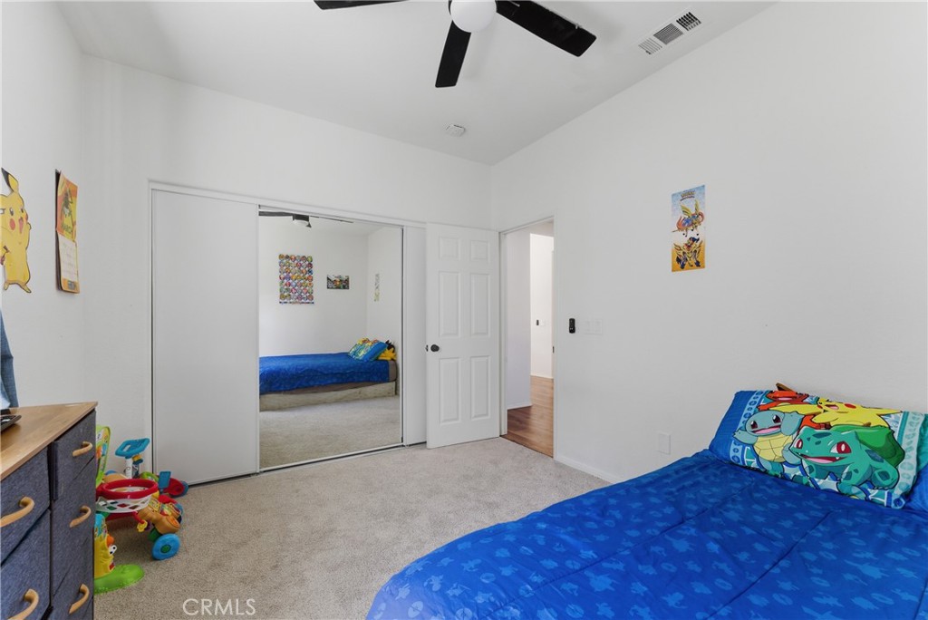 2036 East Jenner Street Lancaster, CA 93535 - Photo 44 of 50 a bedroom with a bed and a wooden floor