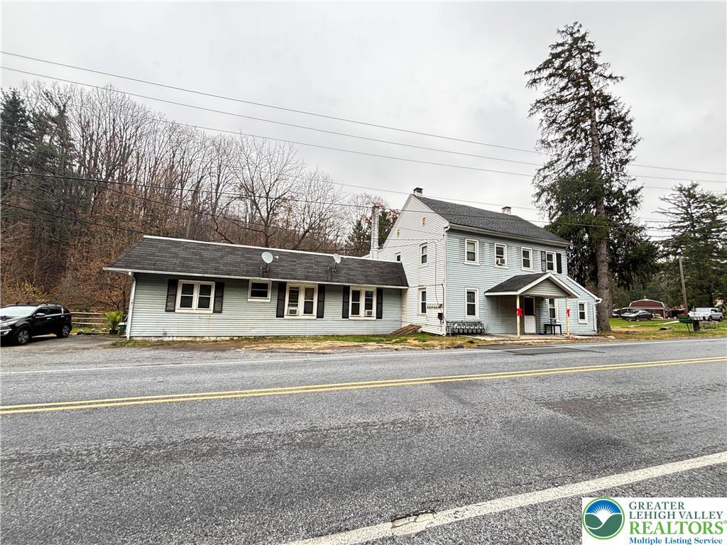 4731 Vera Cruz Road, Unit 6 Emmaus, PA 18049 - Photo 1 of 16 a view of white house with a large space and large trees