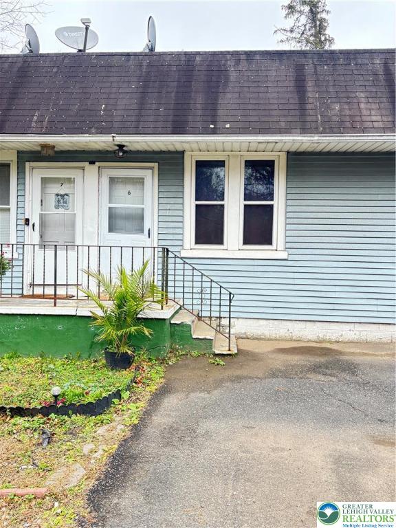 4731 Vera Cruz Road, Unit 6 Emmaus, PA 18049 - Photo 2 of 16 a front view of a house with garden