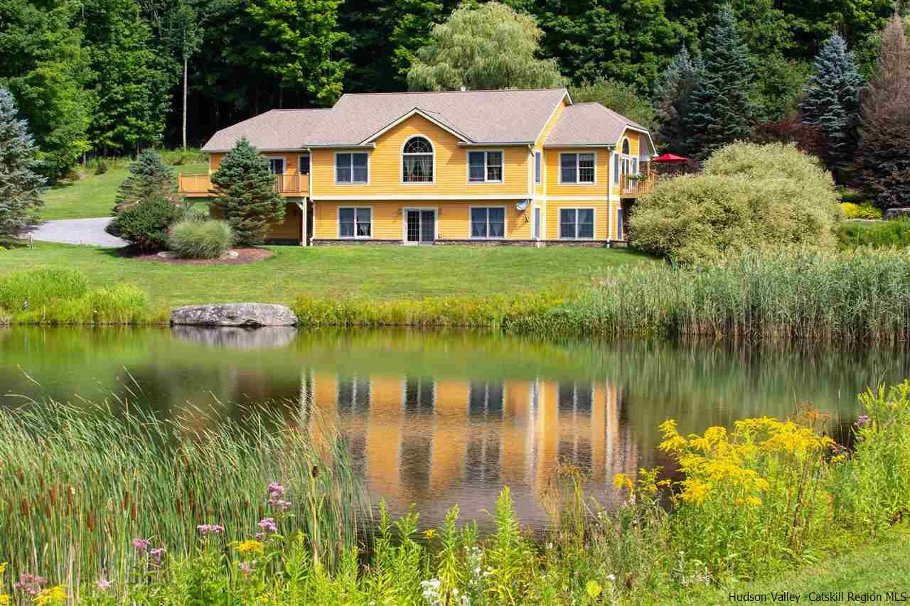 3135 Canada Hollow Road Andes, NY 13731 - Photo 1 of 33 a view of a house next to a lake with a big yard and potted plants