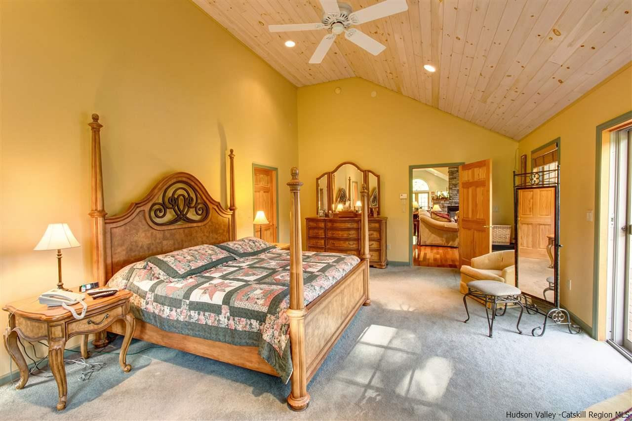 3135 Canada Hollow Road Andes, NY 13731 - Photo 16 of 33 a bedroom with a bed a table and large windows