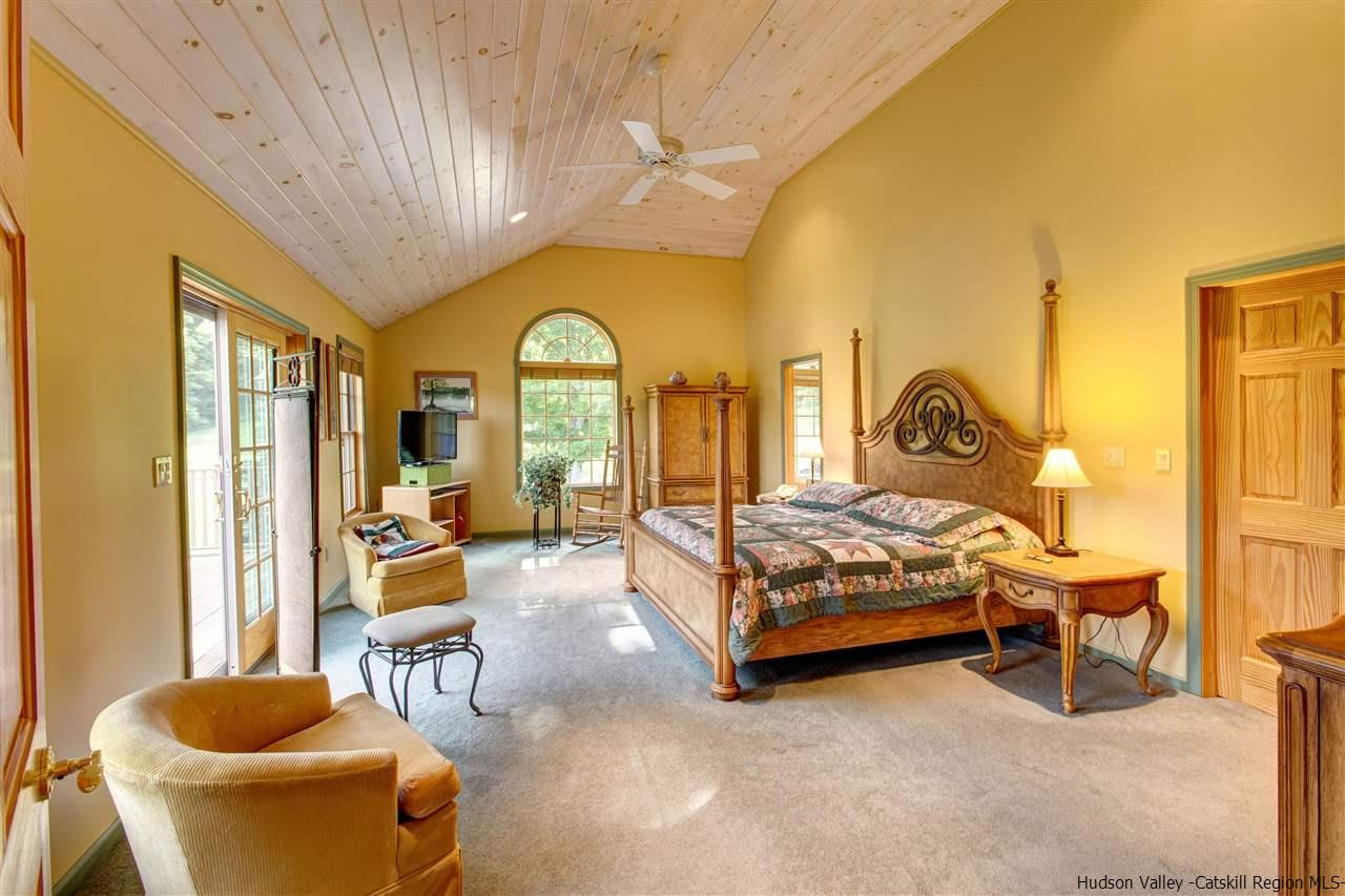 3135 Canada Hollow Road Andes, NY 13731 - Photo 17 of 33 a bedroom with a bed and a chandelier