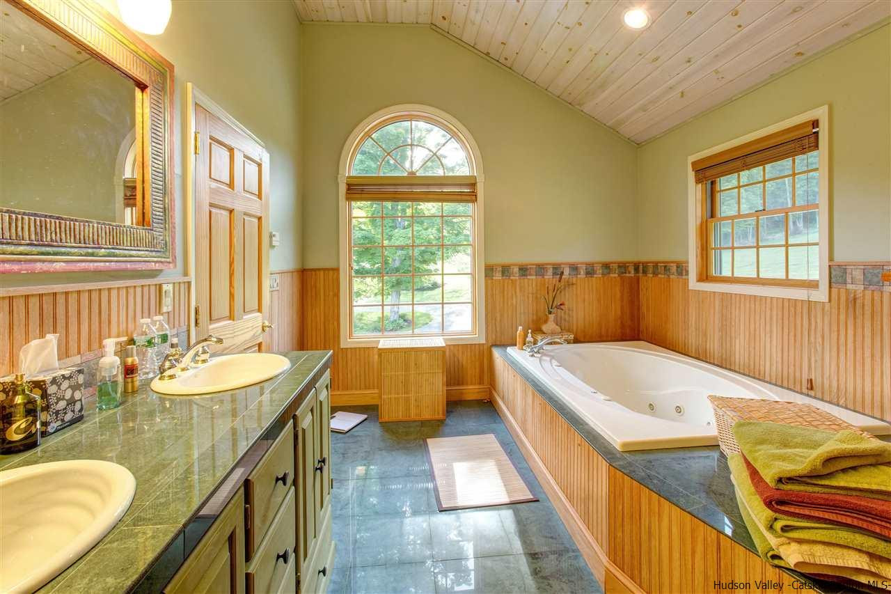 3135 Canada Hollow Road Andes, NY 13731 - Photo 18 of 33 a spacious bathroom with a granite countertop tub sink and mirror