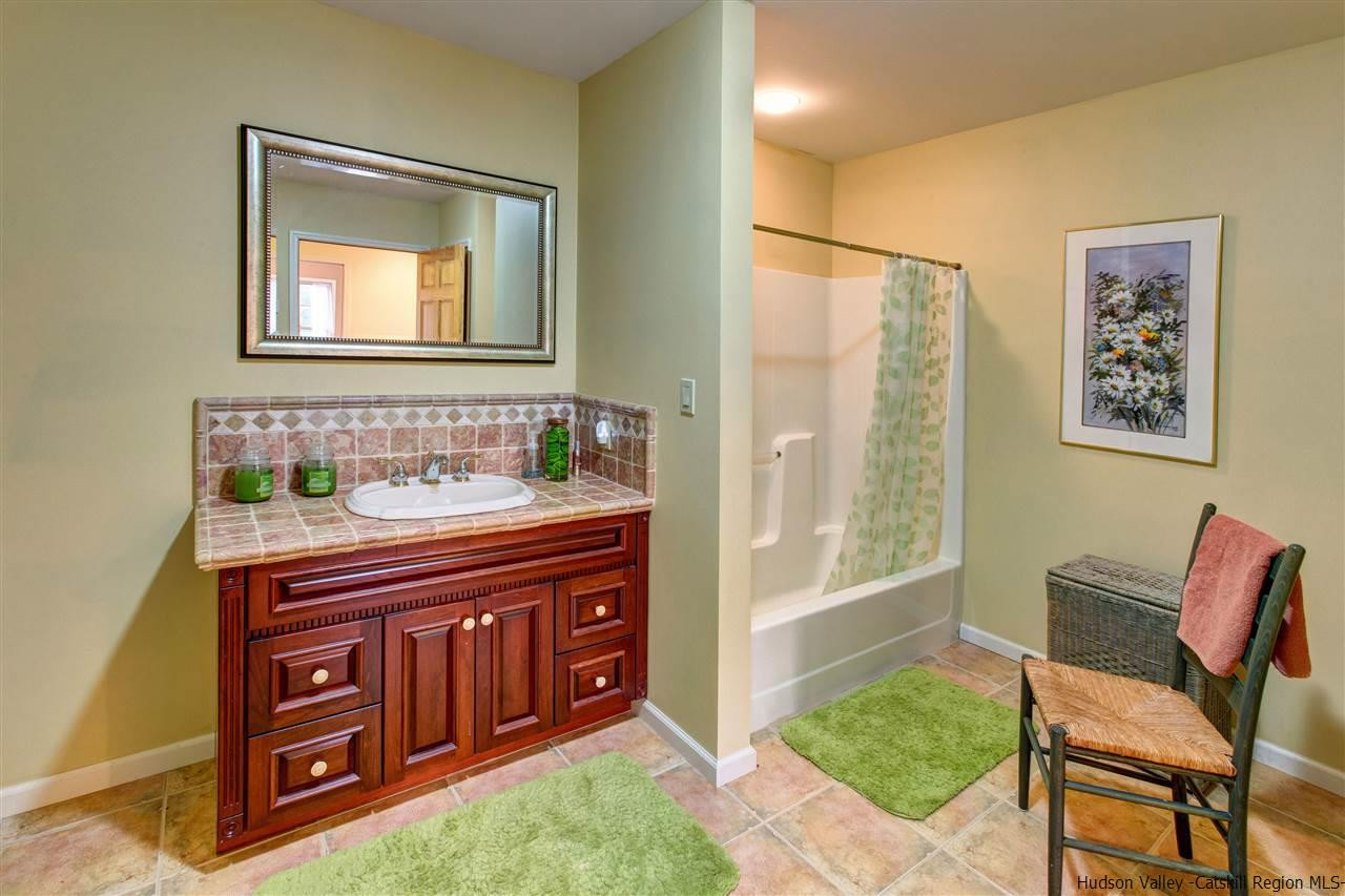 3135 Canada Hollow Road Andes, NY 13731 - Photo 24 of 33 a bathroom with a sink a mirror and a bathtub