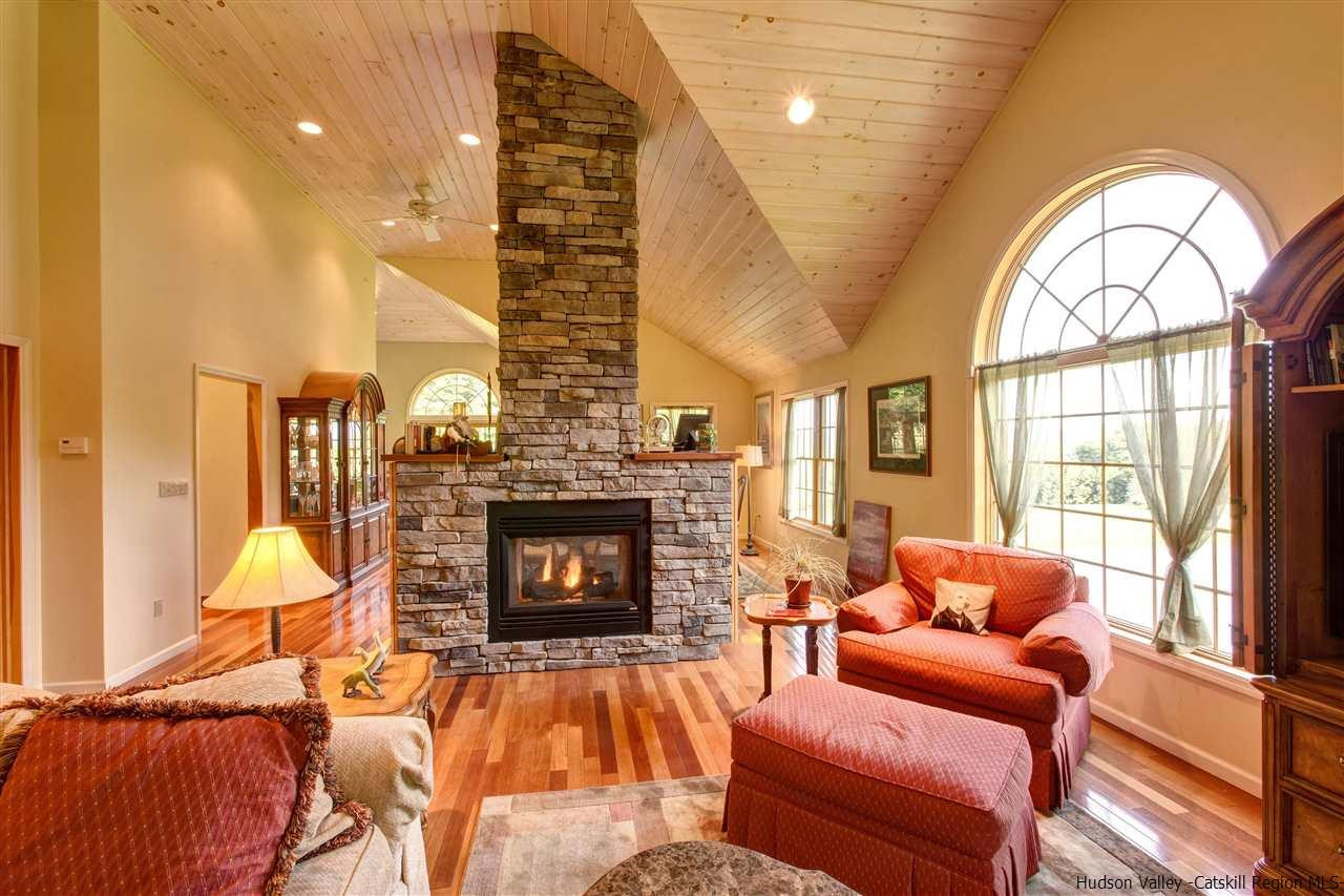 3135 Canada Hollow Road Andes, NY 13731 - Photo 7 of 33 a living room with furniture a fireplace and a dining table with wooden floor