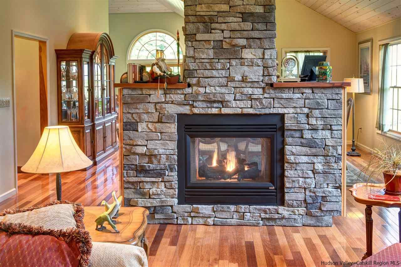 3135 Canada Hollow Road Andes, NY 13731 - Photo 8 of 33 a living room with furniture a fireplace and a flat screen tv
