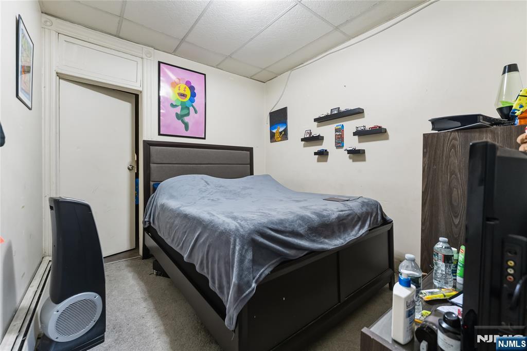 123 47th Street Union City, NJ 07087 - Photo 14 of 27 a bedroom with a bed garage and window