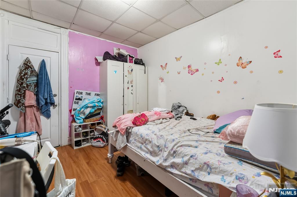 123 47th Street Union City, NJ 07087 - Photo 17 of 27 a bed room with a bed and a couch