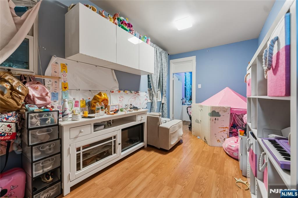 123 47th Street Union City, NJ 07087 - Photo 19 of 27 a bed room with a bed and a television