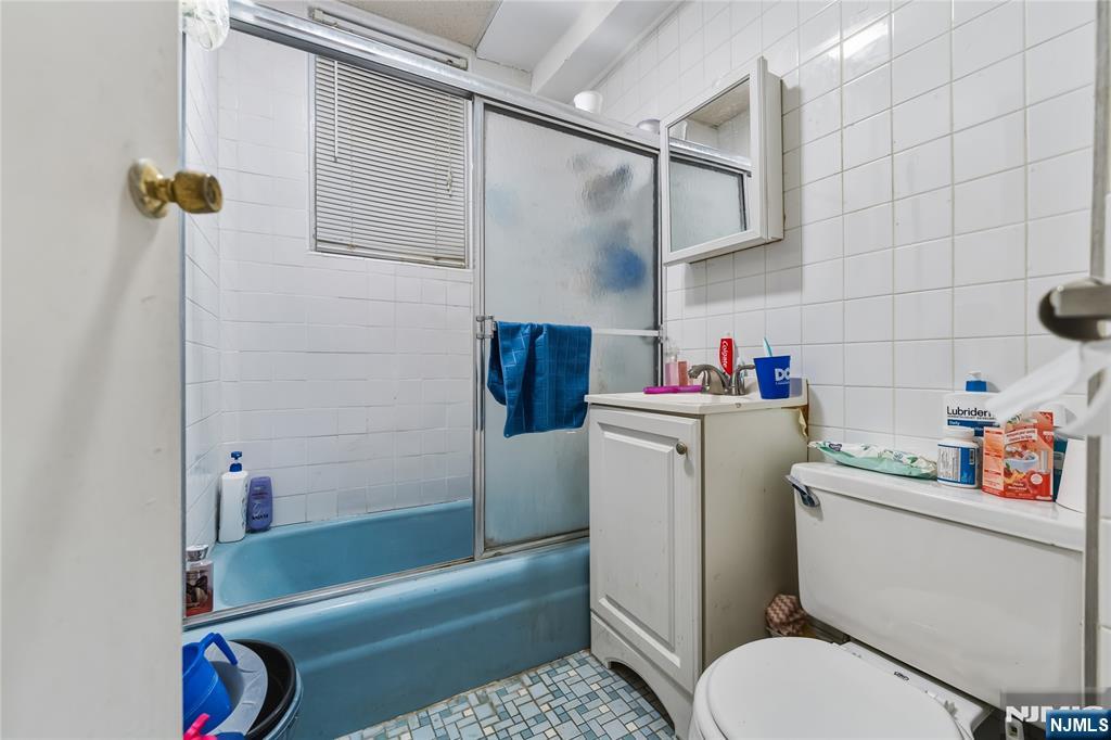 123 47th Street Union City, NJ 07087 - Photo 20 of 27 a bathroom with a sink toilet and shower
