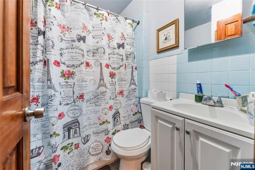 123 47th Street Union City, NJ 07087 - Photo 21 of 27 a bathroom with a sink and a toilet