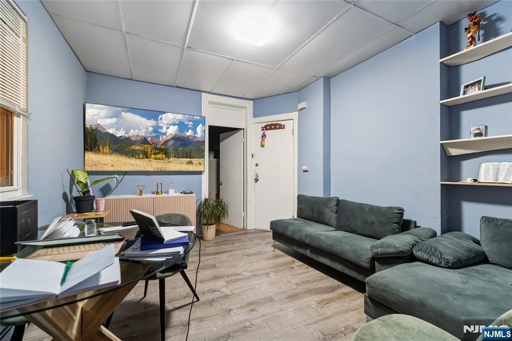 123 47th Street Union City, NJ 07087 - Photo 4 of 27 a living room with furniture and a flat screen tv
