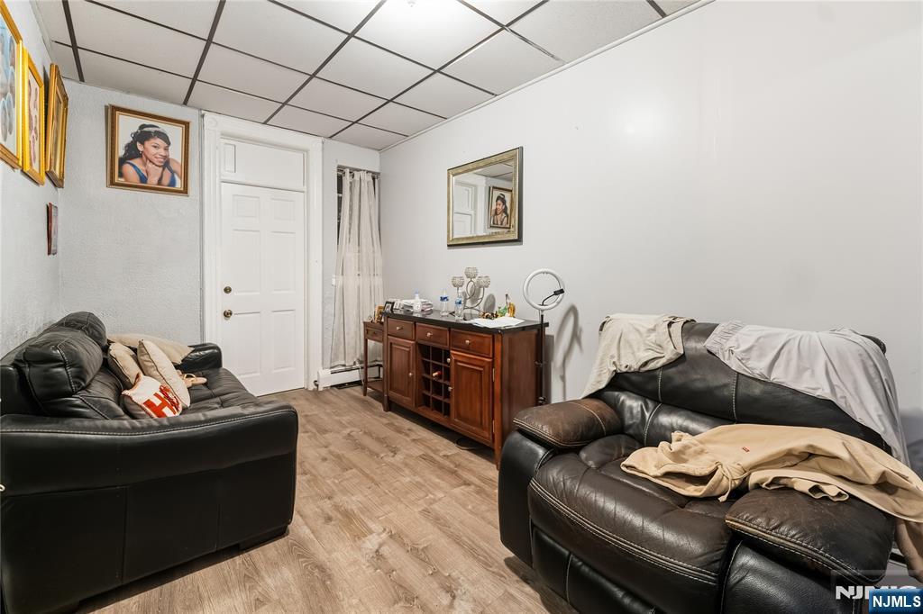 123 47th Street Union City, NJ 07087 - Photo 9 of 27 a living room with furniture and dresser