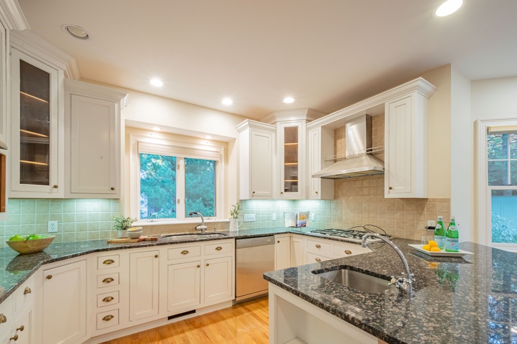 40 Winthrop Road Lexington, MA 02421 - Photo 11 of 42 a kitchen with granite countertop a sink white cabinets and window