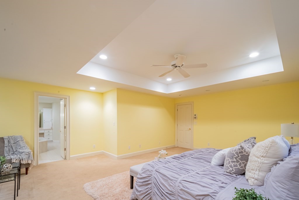 40 Winthrop Road Lexington, MA 02421 - Photo 27 of 42 a bedroom with a bed and a chandelier
