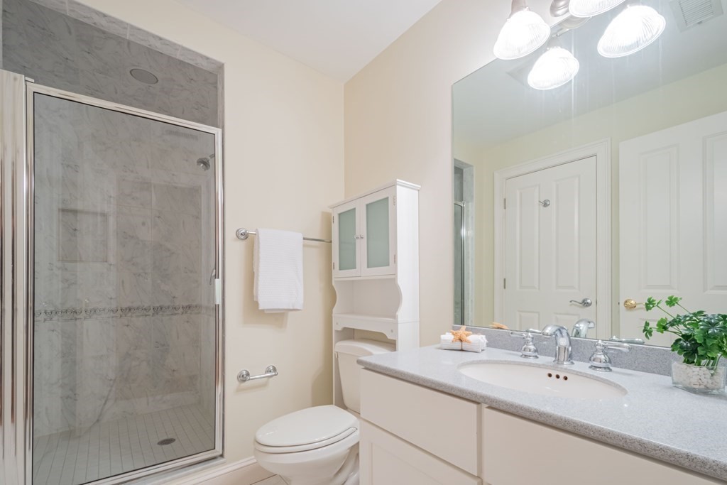 40 Winthrop Road Lexington, MA 02421 - Photo 32 of 42 a bathroom with a bathtub shower sink vanity and toilet
