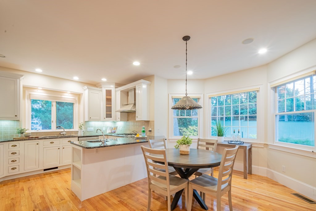 40 Winthrop Road Lexington, MA 02421 - Photo 10 of 42 a kitchen with a table chairs sink and cabinets
