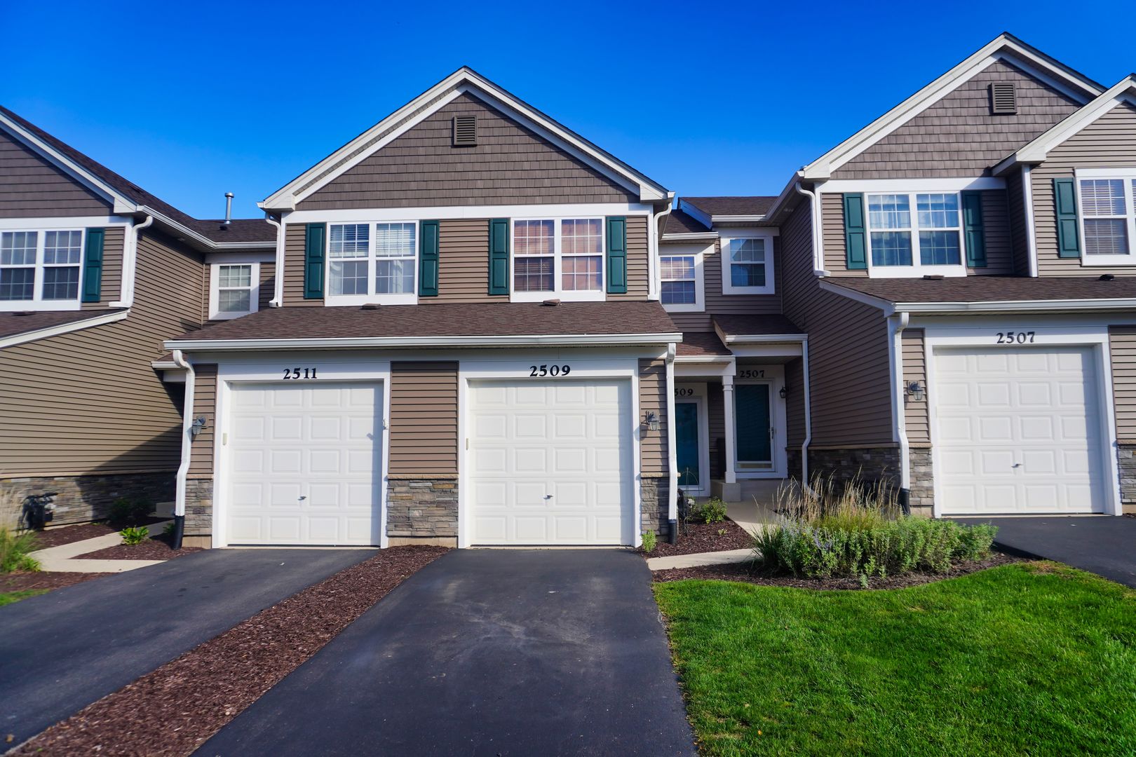 a front view of a house with a yard and garage