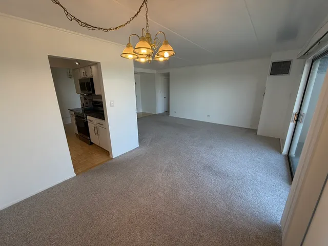 a view of an empty room with a chandelier