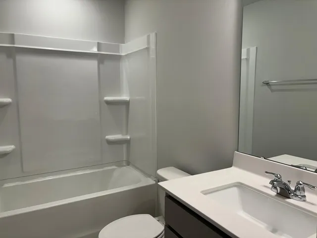a bathroom with a sink a toilet and a bathtub