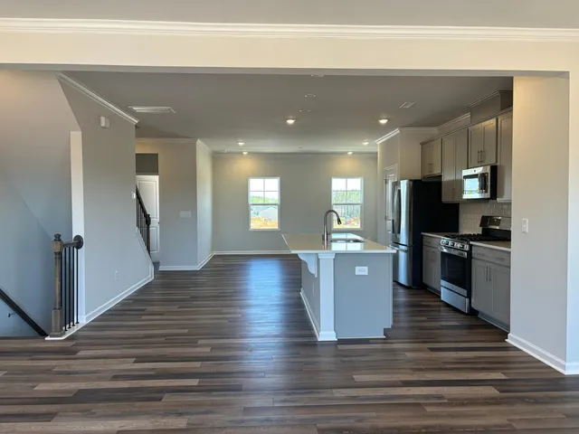 a view of a living room kitchen and a wooden floor
