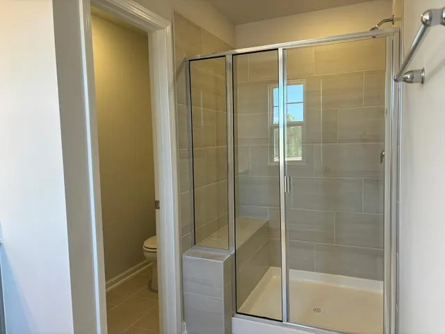 a bathroom with a glass shower door